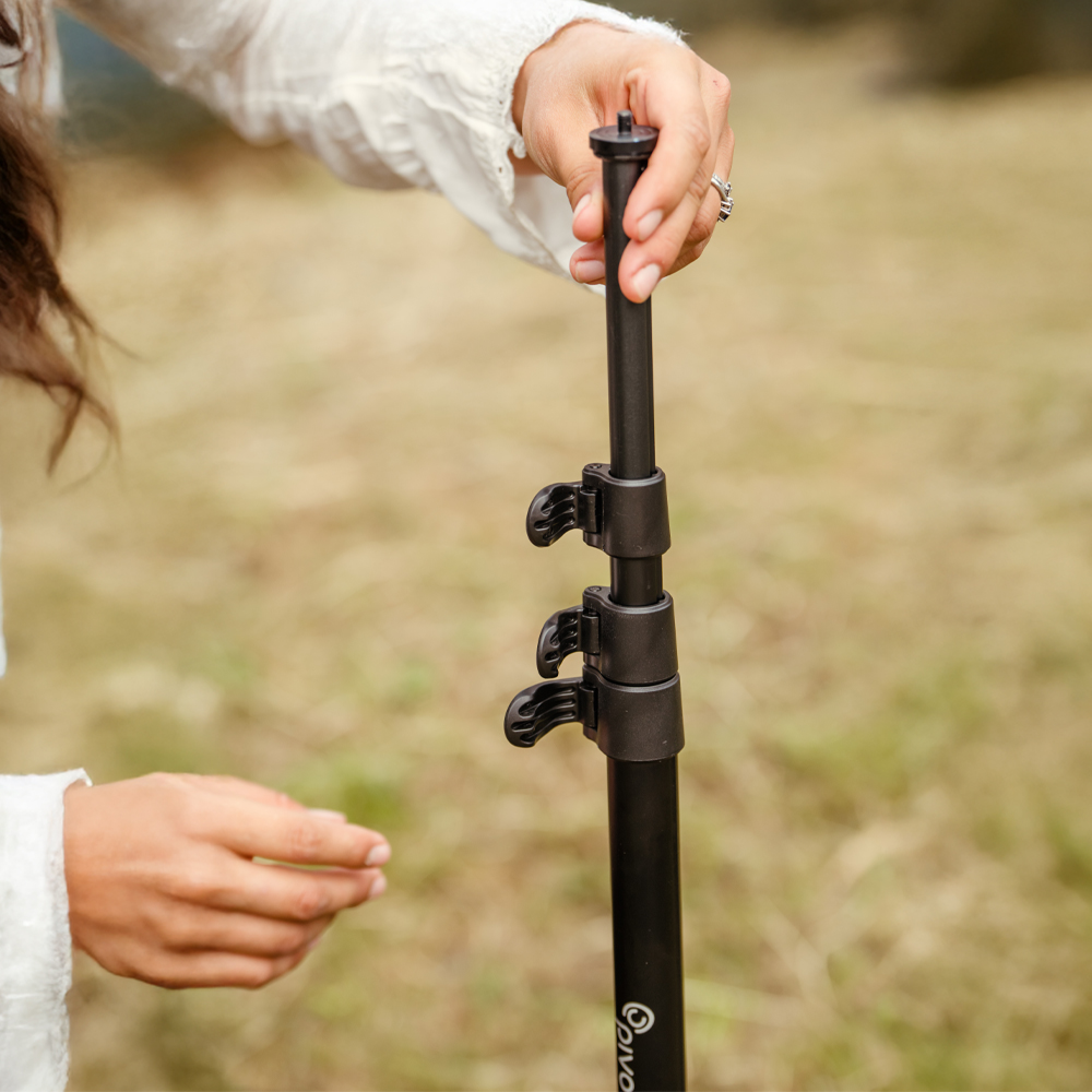 Pivo Tripod with adjustable height feature being set up outdoors.